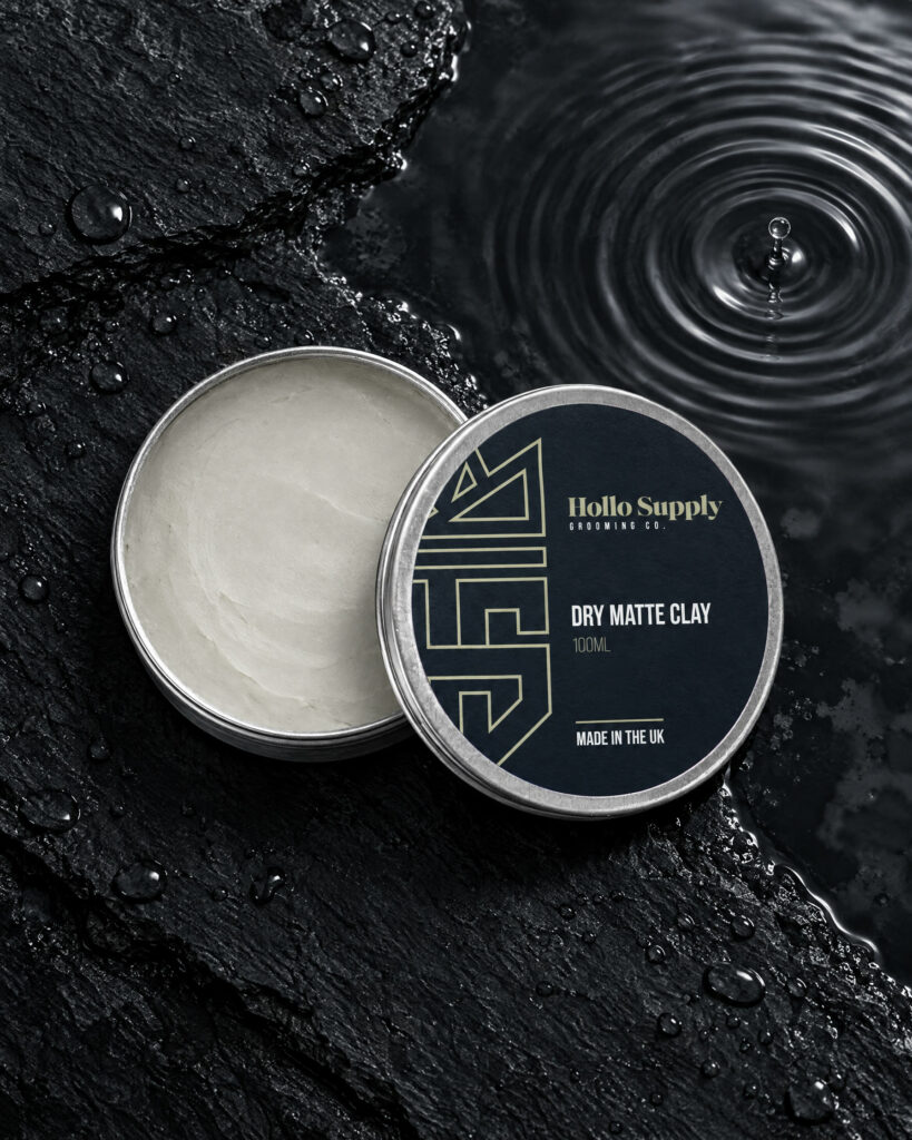 Dry Matte Clay (100ml) by Hollo Supply Grooming Co., photographed on wet charcoal stone with water