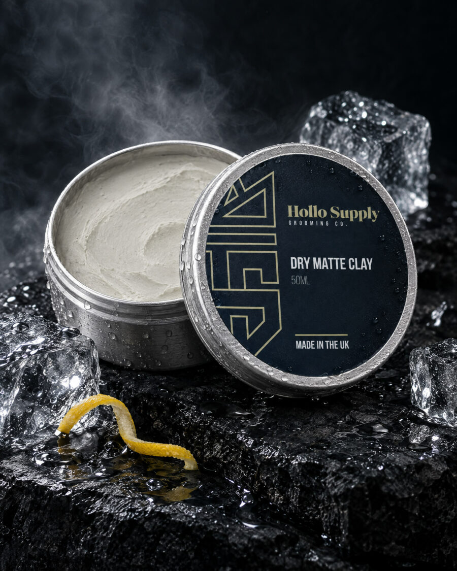 Dry Matte Clay (50ml) by Hollo Supply Grooming Co., photographed on wet charcoal stone with water