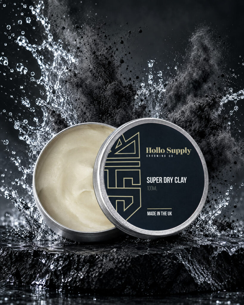 Super Dry Clay (100ml) by Hollo Supply Grooming Co., photographed on wet charcoal stone with water