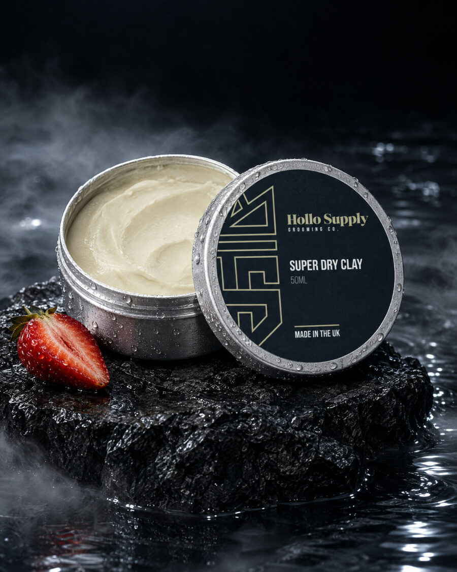 Super Dry Clay (50ml) by Hollo Supply Grooming Co., photographed on wet charcoal stone with water
