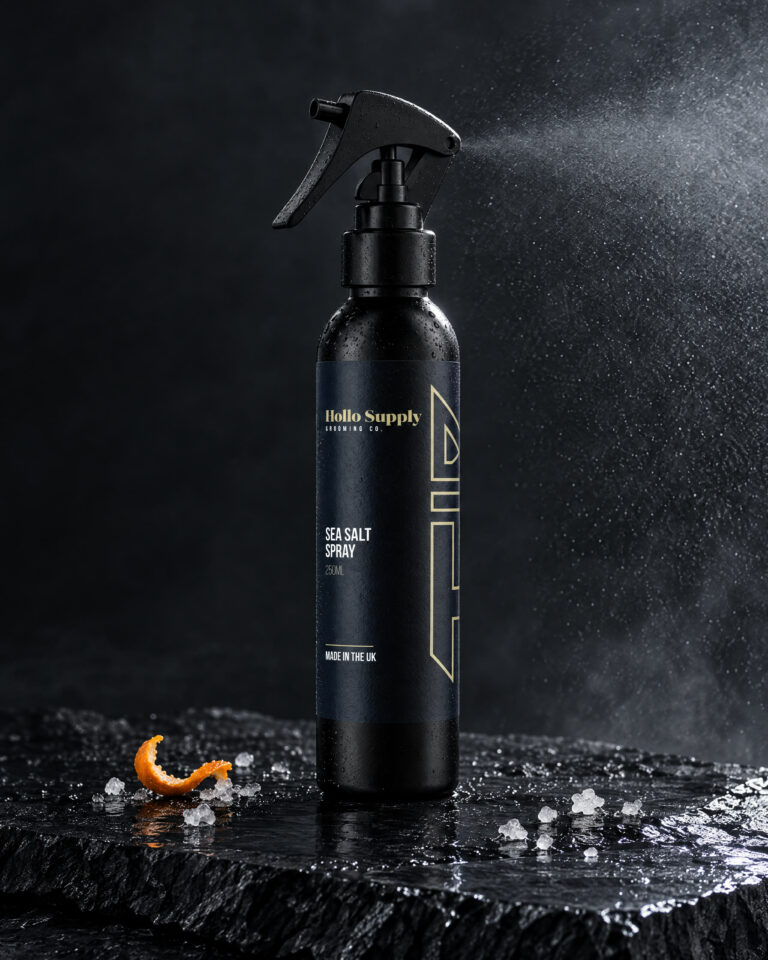 Sea Salt Spray by Hollo Supply Grooming Co., photographed on wet charcoal stone with water