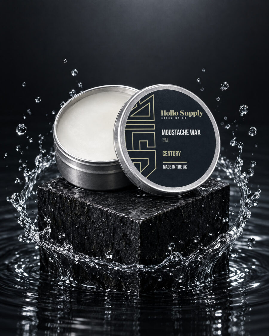 Moustache Wax (Century) by Hollo Supply Grooming Co., photographed on wet charcoal stone with water