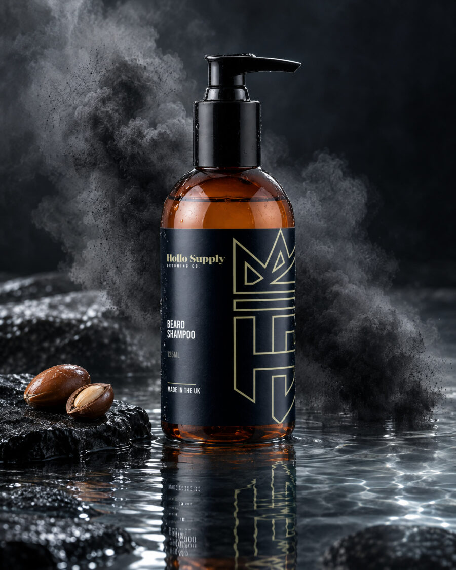 Beard Shampoo by Hollo Supply Grooming Co., photographed on wet charcoal stone with water