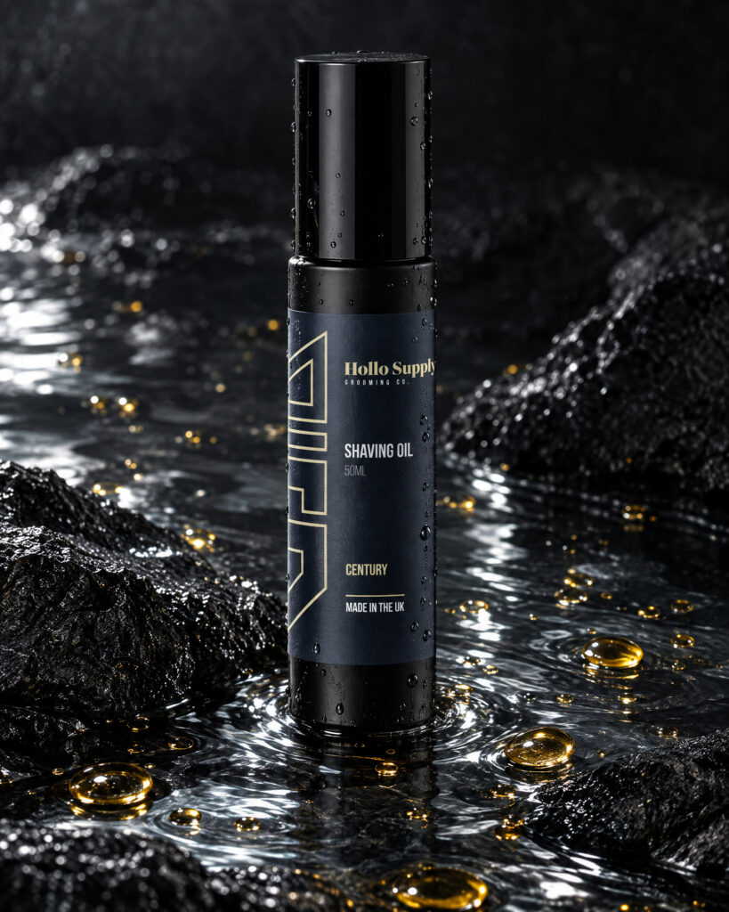 Shave Oil (Century) by Hollo Supply Grooming Co., photographed on wet charcoal stone with water