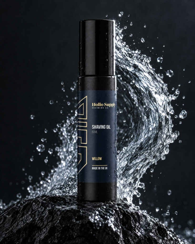 Shave Oil (Willow) by Hollo Supply Grooming Co., photographed on wet charcoal stone with water