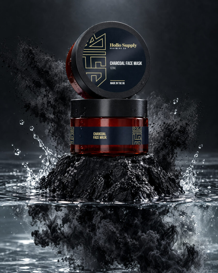 Charcoal Face Mask by Hollo Supply Grooming Co., photographed on wet charcoal stone with water