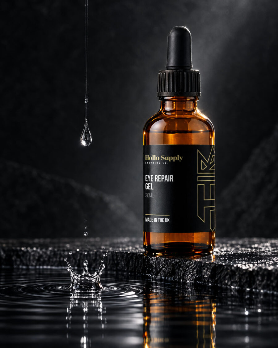 Elixir Eye Repair Gel by Hollo Supply Grooming Co., photographed on wet charcoal stone with water