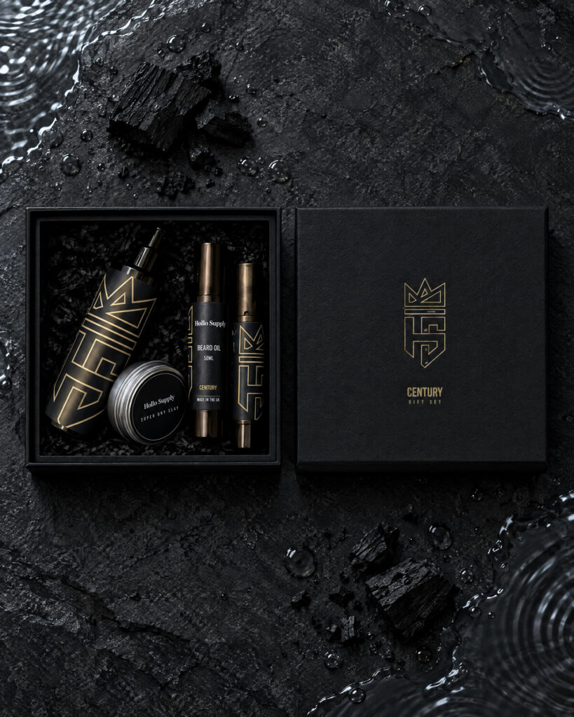 The Century Gift Set by Hollo Supply Grooming Co., photographed on wet charcoal stone with water